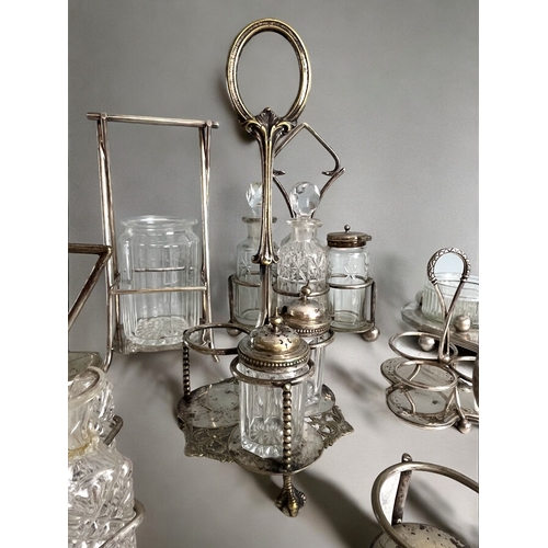 517 - A collection of 19th century silver plate condiment sets & stands. In the manner of Christopher ... 