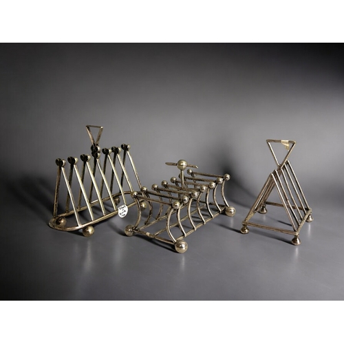 101 - A collection of three 19th century silver plate toast racks. Christopher Dresser style designs. Incl... 