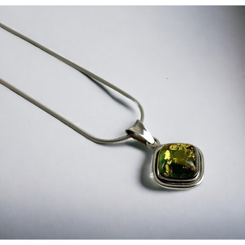 620 - A reconstituted Amber pendant and silver chain.