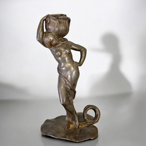 439 - Charles Théodore Perron (1862-1934) Spelter figural candlestick.Depicting a nude with lily bud to he... 