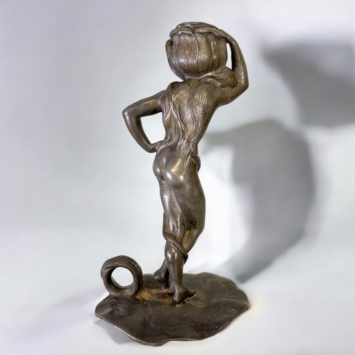 439 - Charles Théodore Perron (1862-1934) Spelter figural candlestick.Depicting a nude with lily bud to he... 