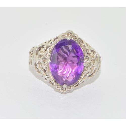 639 - 925 silver Amethyst diamond shape statement ring in an open work scroll design setting size N