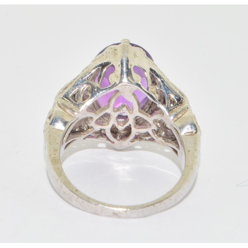 639 - 925 silver Amethyst diamond shape statement ring in an open work scroll design setting size N