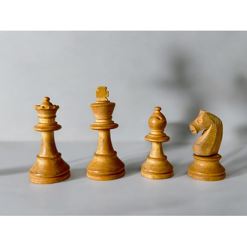 559 - An Early 20thC carved wooden chess set.