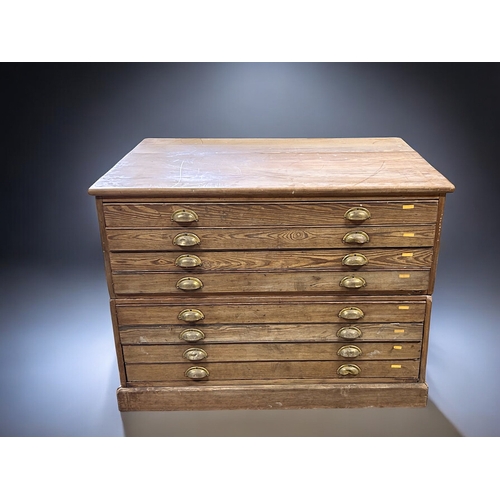 121 - A George V Pitch Pine Government plan chest.Circa 1920.Splits in two, eight drawers with brass cup h... 