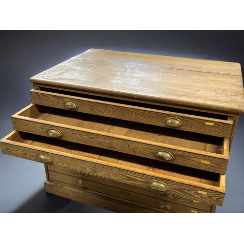 121 - A George V Pitch Pine Government plan chest.Circa 1920.Splits in two, eight drawers with brass cup h... 