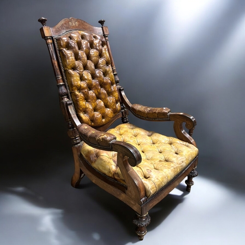 133 - A 19th century carved Rosewood & leather library chair.Leather button back, with carved feet and... 