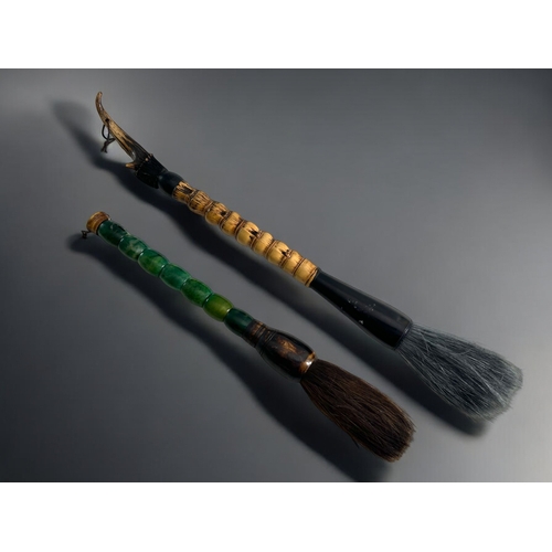 53 - Two Chinese calligraphy brushes.One with bamboo and horn handle. The second with green polished ston... 