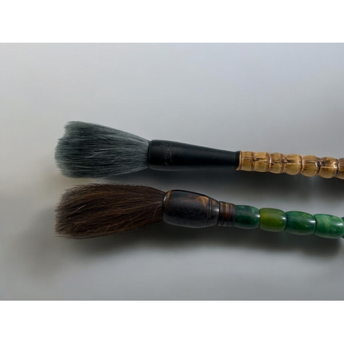 53 - Two Chinese calligraphy brushes.One with bamboo and horn handle. The second with green polished ston... 