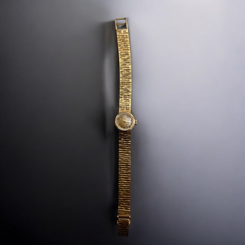 506 - A vintage ladies 9ct Gold Omega cocktail wristwatch.With 9ct gold bark effect strap.Both hallmarked.... 