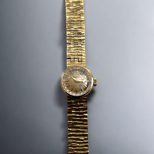 506 - A vintage ladies 9ct Gold Omega cocktail wristwatch.With 9ct gold bark effect strap.Both hallmarked.... 