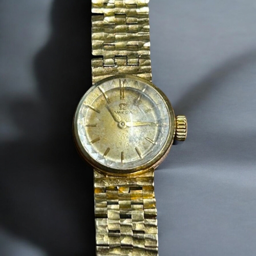 506 - A vintage ladies 9ct Gold Omega cocktail wristwatch.With 9ct gold bark effect strap.Both hallmarked.... 