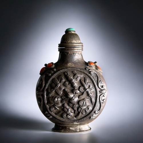 55 - Tibetan silver snuff bottle.C1800-50. Mounted with coral & turquoise. Roundel to each side Relie... 