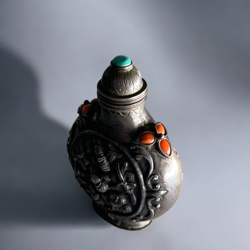 55 - Tibetan silver snuff bottle.C1800-50. Mounted with coral & turquoise. Roundel to each side Relie... 