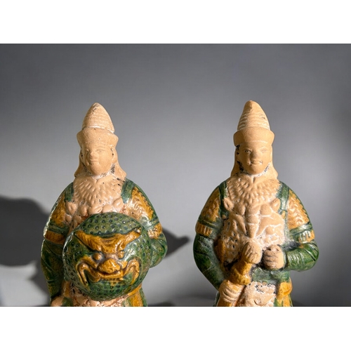 84 - A pair of Chinese Ming style Tomb warrior guards.Sancai glazed, displaying weapons and armoured unif... 