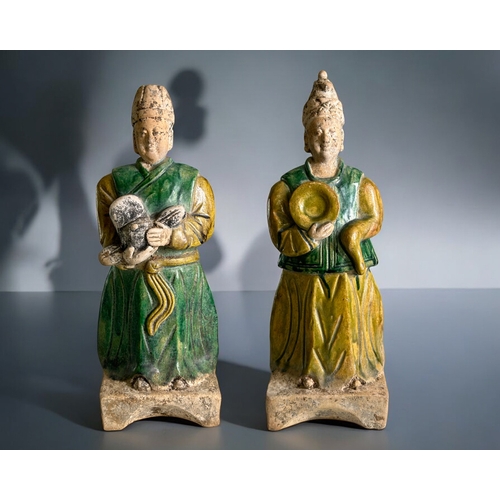 85 - A pair of Chinese Ming style Tomb attendants.Sancai glazed in greens & ochre. Stood on concave b... 