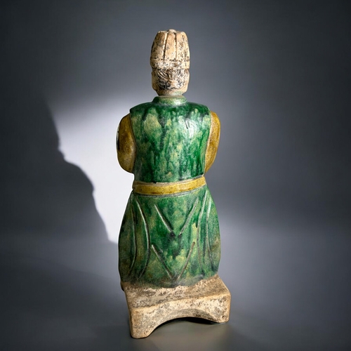 85 - A pair of Chinese Ming style Tomb attendants.Sancai glazed in greens & ochre. Stood on concave b... 