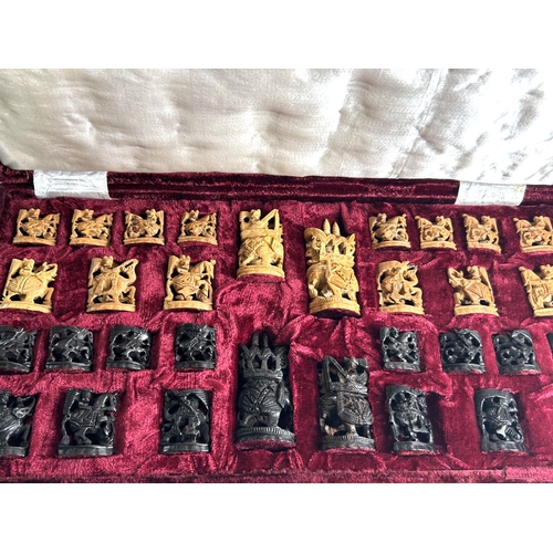 560 - A vintage cased Indian carved wood Ambari Elephant chess set.Ebony & Kadam.