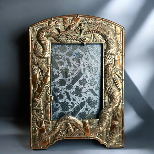 88 - A collection of four Japanese antimony photo frames.Including a pair embossed with Dragons contestin... 