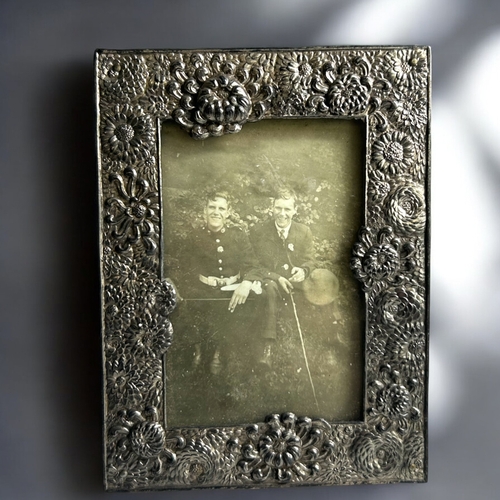 88 - A collection of four Japanese antimony photo frames.Including a pair embossed with Dragons contestin... 