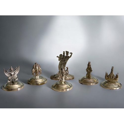 90 - A set of five Siam sterling silver Menu place holders.Depicting various Deities. Together with one o... 