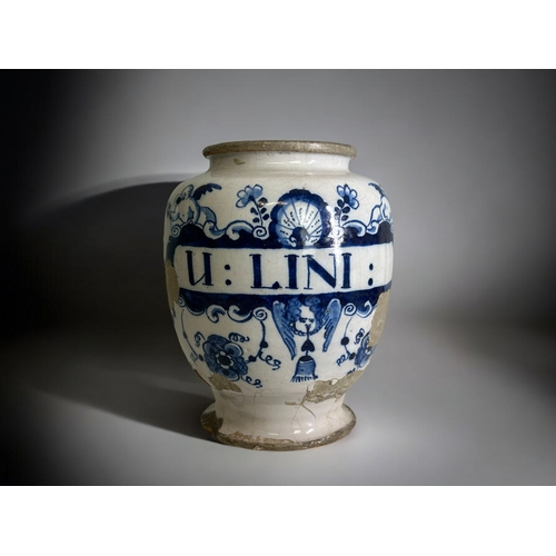 417 - An early 18th century English Delftware Apothecary jar.Hand painted foliate & Putti design. Insc... 