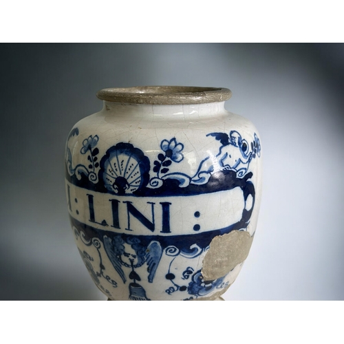 417 - An early 18th century English Delftware Apothecary jar.Hand painted foliate & Putti design. Insc... 