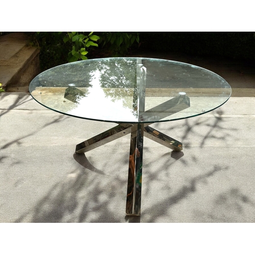 151 - A Chrome & glass dining table.'Cross' design legs. Removable round glass top.approx 176 diameter... 