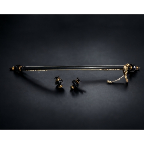 110 - A LARGE GILDED & EBONISED CURTAIN POLE. WITH ADDITIONAL CARVED ENDS.