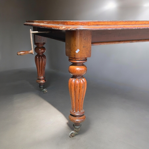 158 - A large Mahogany wind extending dining table.With original leaves. Turned & fluted legs, raised ... 