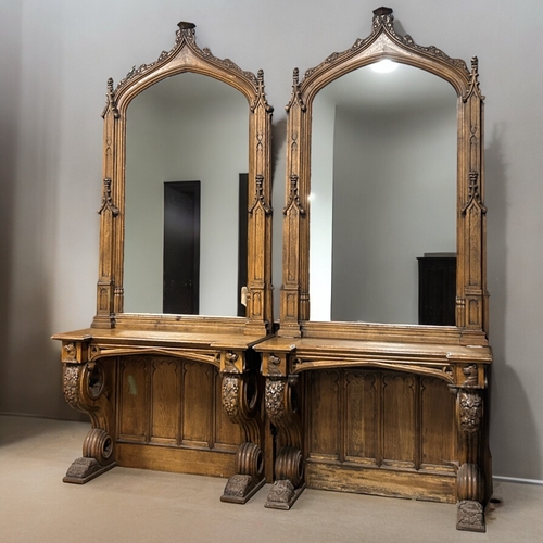 159 - A huge pair of Gothic style carved Oak mirrored console tables. Standing at approximately 10.6ft tal... 