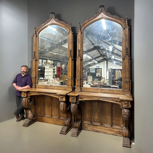 159 - A huge pair of Gothic style carved Oak mirrored console tables. Standing at approximately 10.6ft tal... 