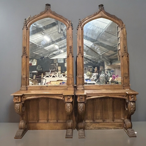 159 - A huge pair of Gothic style carved Oak mirrored console tables. Standing at approximately 10.6ft tal... 