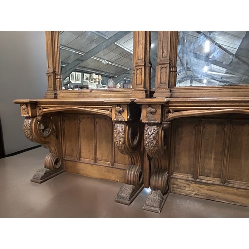 159 - A huge pair of Gothic style carved Oak mirrored console tables. Standing at approximately 10.6ft tal... 