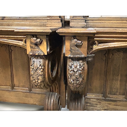 159 - A huge pair of Gothic style carved Oak mirrored console tables. Standing at approximately 10.6ft tal... 