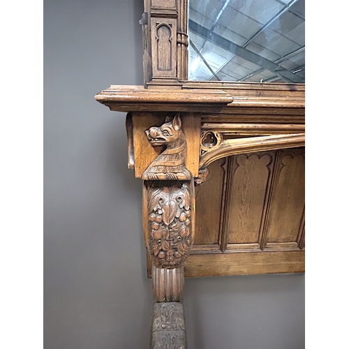 159 - A huge pair of Gothic style carved Oak mirrored console tables. Standing at approximately 10.6ft tal... 