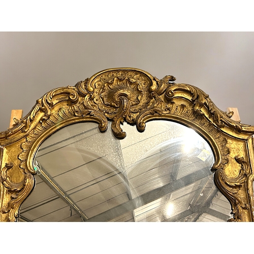 160 - A huge Louis XVI style carved gilt wood mirror.France, 19th century.Stylised scrolling designHeight ... 