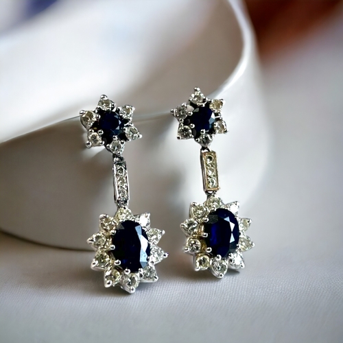 550 - A PAIR OF 18 CARAT WHITE GOLD, DIAMOND & SAPPHIRE DROP EARRINGS. Each set with an Oval & rou... 