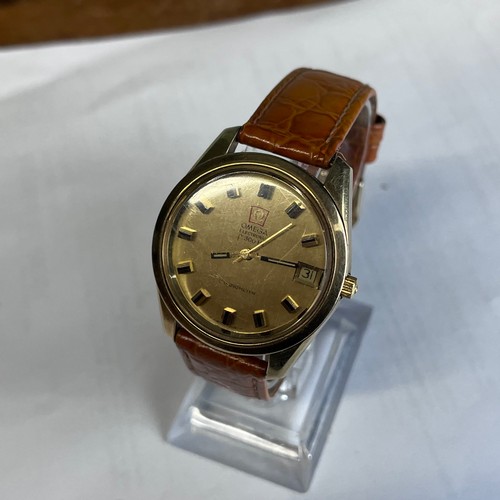 551 - A 1970's OMEGA F300HZ CHRONOMETER MENS WRISTWATCH. Gold case, with polished gold dial and raised bla... 