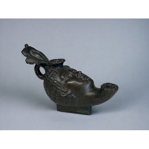 451 - A GRAND TOUR BRONZE 'ROMAN' OIL LAMP. 19th Century. Modelled as a woman's head with elaborate head d... 