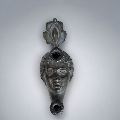 451 - A GRAND TOUR BRONZE 'ROMAN' OIL LAMP. 19th Century. Modelled as a woman's head with elaborate head d... 