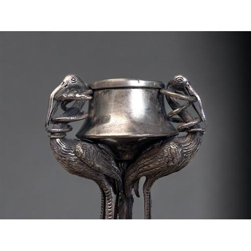 520 - A 19th CENTURY SILVER PLATE INKWELL.
Depicting three tall Cranes, each with a snake in their mouth. ... 