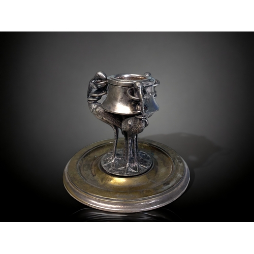 520 - A 19th CENTURY SILVER PLATE INKWELL.
Depicting three tall Cranes, each with a snake in their mouth. ... 