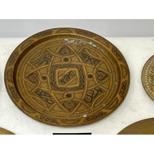 360 - A Large Copper inlaid on Brass Persian Platter and Indian Brass Hand Hammered plates with 2 other br... 