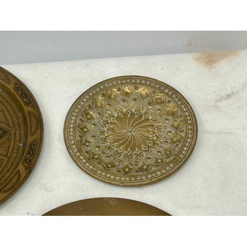 360 - A Large Copper inlaid on Brass Persian Platter and Indian Brass Hand Hammered plates with 2 other br... 