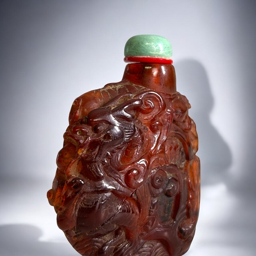 70 - Chinese carved Amber snuff bottle.Qing dynasty, 18th/19th Century.Irregular form, with intricately C... 