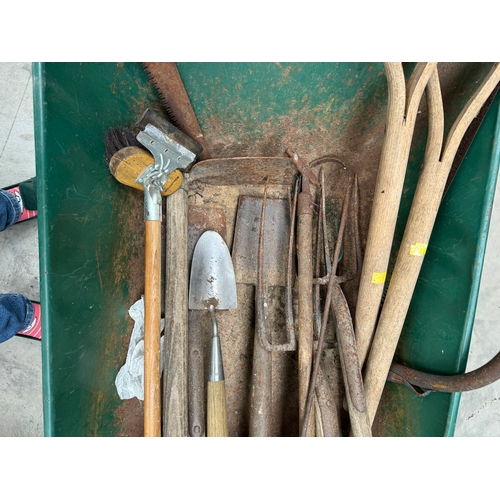 385 - A dozen of garden ustensils containing forks, spades, rakes etc. along with a wheelbarrow and a pair... 