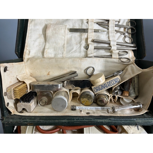 574 - A vintage leather field / Midwifery medical case.Complete with various medical equipment.