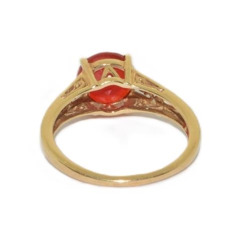 46 - 9ct gold ladies Orange colour quarts round solitaire ring in an open work scroll setting size O