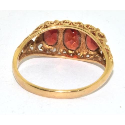 275 - 9ct gold vintage Garnet 3 stone ring in a scroll work setting size P